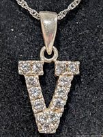 Close-up of pendant front showing V shape and CZ stones