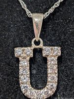 Close-up of U pendant showing CZ stones and bail