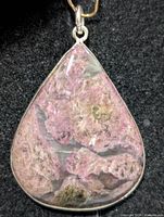 Front view of rhodonite teardrop pendant in silver setting