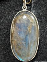 Front view of oval labradorite pendant in silver bezel