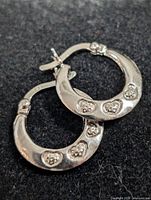 Front view of both sterling silver hoops showing heart CZ details