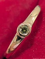 Close-up of bezel-set diamond on silver ring