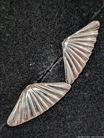 Both earrings front view on dark background