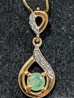 Front view showing emerald and clear stone accents