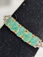 Close-up of emerald row on ring