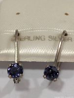 Front view of earrings on card showing stones and setting