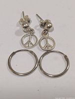 Stud drop and hoop earrings side by side