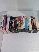 Row of 16 VHS tapes front spines visible