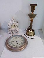 Group shot of mantel clock, wall clock, and lamp base