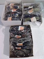 Four boxes containing packaged sunglasses
