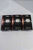 Three boxed Duracell Powermat chargers front view