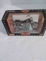 Front view of boxed model showing motorcycle and packaging