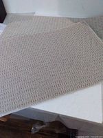 Both beige mats laid out showing size and color