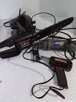 Group view of Remington chainsaw, Skil jigsaw, Mastercraft spin saw, cords