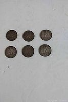 Six coins reverse side showing eagle design