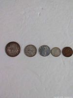 Front view of all five 1944 Canadian coins aligned by denomination