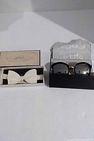 Bow tie box and sunglasses box side by side