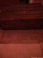 Closed wooden trunk front view showing wood slats and metal bands