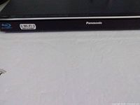Front view showing Panasonic logo and Blu-ray, Wi-Fi stickers