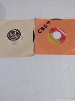 Both records in their sleeves side by side