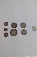 All eight coins laid out showing relative sizes