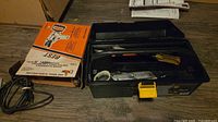 Drill box, toolbox open with assorted hand tools