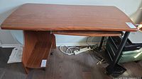 Full view of desk showing top surface, side panel, keyboard tray, metal legs