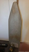 Full view of ironing board standing upright