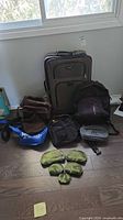 Group shot showing suitcase, backpacks, bags, tote and pouches