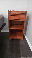 Front view of maple nightstand showing drawer, shelf, feet