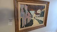 Framed oil painting hung on wall showing full view