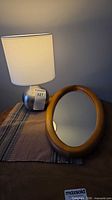 Mirror and lamp grouped on table