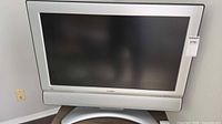 Front view of Sharp 26" LCD TV on stand