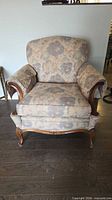 Full front view of upholstered armchair