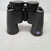Front view of Bushnell waterproof binoculars with lens covers attached