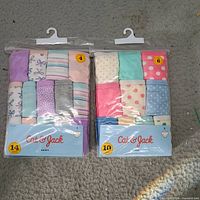 Front view of two sealed Cat & Jack toddler brief packs showing sizes 4 and 6 and assorted colors