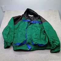 Full view of green Columbia jacket laid flat
