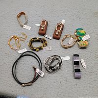 Group shot of all bracelets and belt showing styles and tags