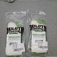 Front view of two sealed Duluth Trading compression sock packages