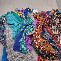 Pile of assorted LuLaRoe garments in various prints and colors