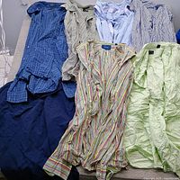 All seven folded shirts laid out showing colors and patterns