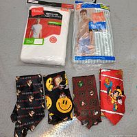 All items in lot: two sealed Hanes packs and four cartoon ties