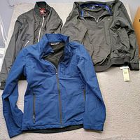 Three jackets laid out showing front and features