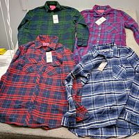 Four plaid shirts laid out showing colours and style