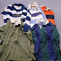 Group shot of five rugby shirts showing colours, collars and stripe patterns