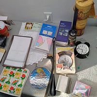 All miscellaneous home goods laid out on tabletop showing variety and condition