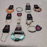 All ten Paparazzi bracelets laid out showing variety and new tags