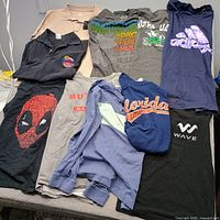 All ten tops laid out showing fronts and graphics