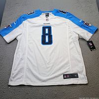 Back view of white Tennessee Titans Marcus Mariota jersey showing number 8, tags, size label
