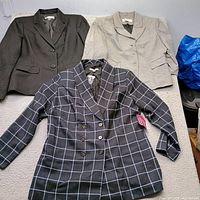 Group shot of three blazers laid flat